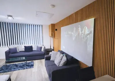 a living room with two blue couches and a painting at Stylish City Escape near Cavern Quarter sleeps 4 in Liverpool