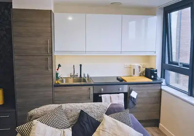 a small kitchen with a sink and a counter at Stylish City Escape near Cavern Quarter sleeps 4 in Liverpool
