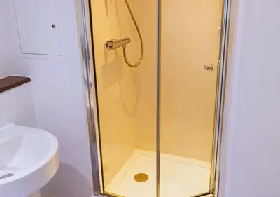 a shower with a glass door next to a sink at Stylish City Escape near Cavern Quarter sleeps 4 in Liverpool