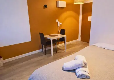 a room with a table and a table and a bed at Stylish City Escape near Cavern Quarter sleeps 4 in Liverpool