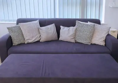 a blue couch with several pillows on it at Stylish City Escape near Cavern Quarter sleeps 4 in Liverpool