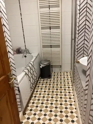 a bathroom with a black and white tiled floor at The lavender house 513 halliwell rd bolton bl18db in Bolton