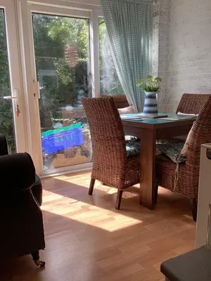 a dining room with a table and chairs and a window at The lavender house 513 halliwell rd bolton bl18db in Bolton
