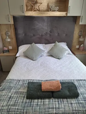 a bedroom with a large bed with two pillows at Inside No.2 Retreat in Carnforth