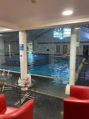 a swimming pool with a table and chairs in a building at Inside No.2 Retreat in Carnforth