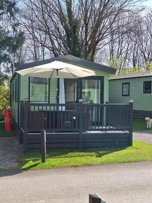 a house with a porch with an umbrella at Inside No.2 Retreat in Carnforth