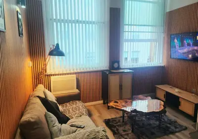 a living room with a couch and a table at The Halifax Suites Near Albert Dock sleeps 3 in Liverpool