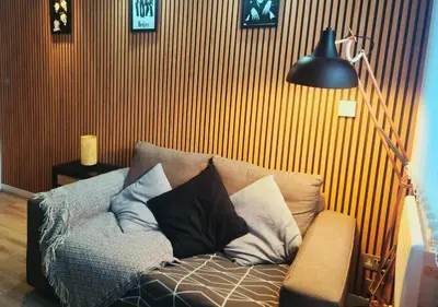 a couch with pillows on it in a living room at The Halifax Suites Near Albert Dock sleeps 3 in Liverpool
