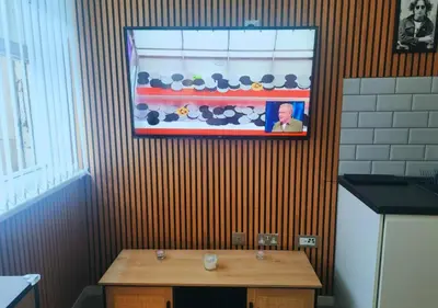 a kitchen with a table and a picture on the wall at The Halifax Suites Near Albert Dock sleeps 3 in Liverpool