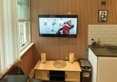 a living room with a tv hanging on a wall at The Halifax Suites Near Albert Dock sleeps 3 in Liverpool