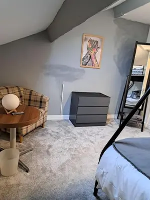 a living room with a couch and a table at Cosy 19th century town-house in Clitheroe