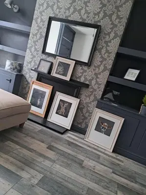 a group of pictures on a wall with a mirror at Cosy 19th century town-house in Clitheroe