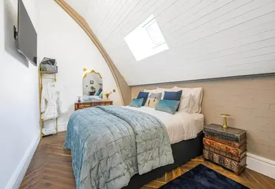 a bedroom with a large bed in a attic at Chapel Apartment in Liverpool