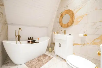a bathroom with a tub and a toilet and a sink at Chapel Apartment in Liverpool