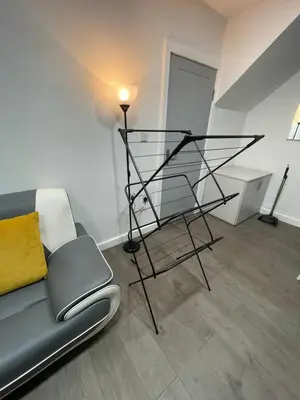 a living room with a couch and a lamp at Galway Suite in Preston