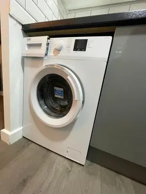a washing machine in a room with a counter at Galway Suite in Preston