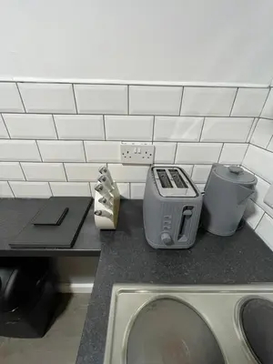 a kitchen with a counter top with a sink and a counter top at Galway Suite in Preston