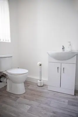 a white bathroom with a toilet and a sink at Balmoral Stays 3 - First Floor in Blackpool