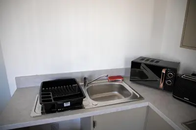 a kitchen counter with a sink and a microwave at Balmoral Stays 3 - First Floor in Blackpool