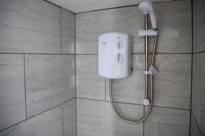 a shower in a bathroom with a shower head at Balmoral Stays 5 - Second Floor in Blackpool