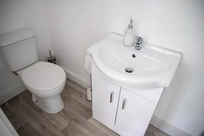 a white bathroom with a toilet and a sink at Balmoral Stays 5 - Second Floor in Blackpool