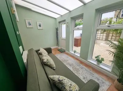 a living room with a couch and a window at Central Lancaster City Centre Terraced Gem in Lancaster