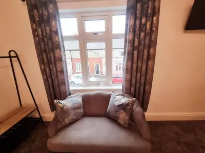 a couch sitting in front of a window at Central Lancaster City Centre Terraced Gem in Lancaster