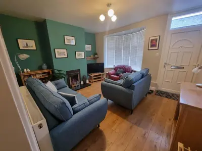 a living room with two couches and a television at Central Lancaster City Centre Terraced Gem in Lancaster