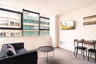 a living room with a couch and a table at Central Preston Lovely 1 Bedroom Apartment in Preston