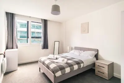 a small bedroom with a bed and a window at Central Preston Lovely 1 Bedroom Apartment in Preston
