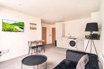 a living room with a couch and a table at Central Preston Lovely 1 Bedroom Apartment in Preston