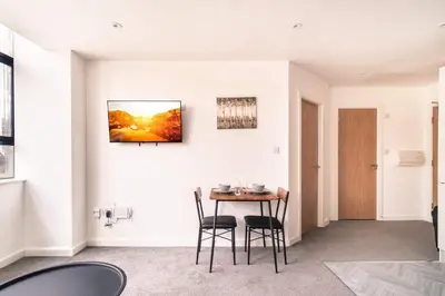 a dining room with a table and chairs at Central Preston Lovely 1 Bedroom Apartment in Preston
