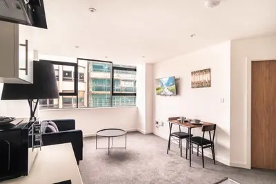 a living room with a couch and a table at Central Preston Lovely 1 Bedroom Apartment in Preston