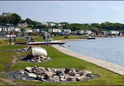 a bunch of rocks on the side of a lake at Sandpiper Port Haverigg Marina in Millom