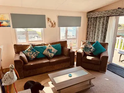 a living room with two couches and a coffee table at Sandpiper Port Haverigg Marina in Millom