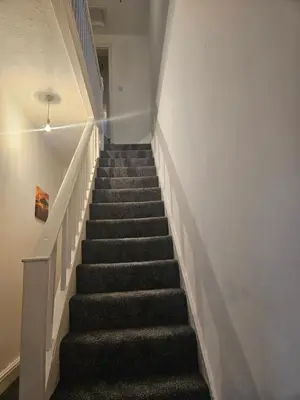 a staircase in a building with a stair case at Liverpool Haven, Stylish and Spacious 3-Bedroom Apartment with City Access in Liverpool