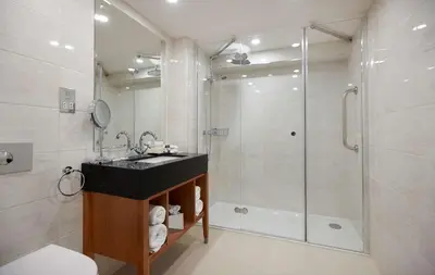a bathroom with a glass shower and a sink at DoubleTree by Hilton Hotel & Spa Liverpool in Liverpool