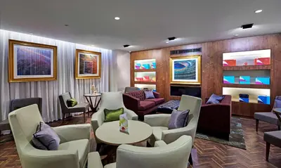 a living room with chairs and a table and a couch at DoubleTree by Hilton Hotel & Spa Liverpool in Liverpool