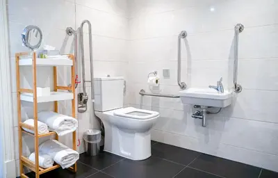 a bathroom with a toilet and a sink at DoubleTree by Hilton Hotel & Spa Liverpool in Liverpool