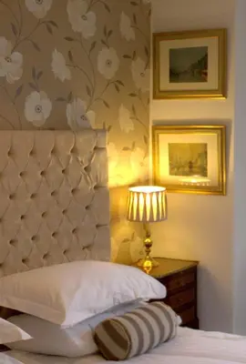 a bedroom with a bed with a headboard and a lamp at The Georgian Town House Hotel in Liverpool