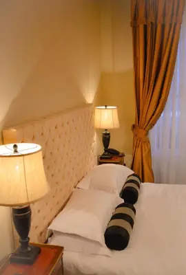 a bedroom with a bed with two lamps and a window at The Georgian Town House Hotel in Liverpool
