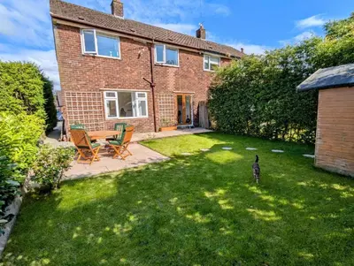 a brick house with a yard with a table and chairs at Bright Double Room l Smart TV l 5 Minute Walk from Train Station in Egerton