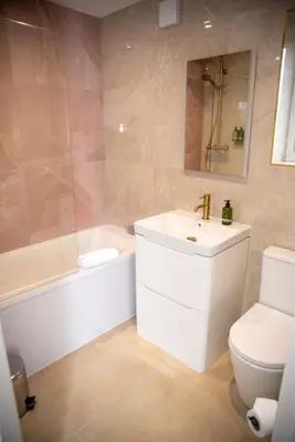 a bathroom with a sink and a tub and a toilet at Highcross Corner in Poulton le Fylde