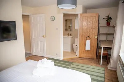 a bedroom with a bed and a bathroom with a toilet at Highcross Corner in Poulton le Fylde