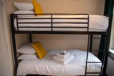 a bunk bed with white pillows and towels at Highcross Corner in Poulton le Fylde