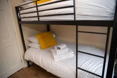 a bunk bed with towels on a white bed at Highcross Corner in Poulton le Fylde