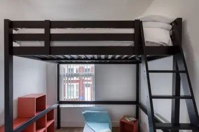 a bedroom with a bunk bed with a ladder at Vibrant Artist Hideaway by Centre Parking in Liverpool
