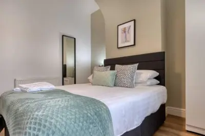 a bedroom with a large bed with pillows on it at Vibrant Artist Hideaway by Centre Parking in Liverpool
