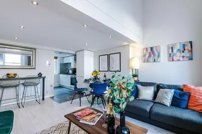 a living room with a couch and a table at NEW! Stunning City Centre 2-bed apartment in Liverpool by 53 Degrees Property, Ideal for Small Groups, Sleeps 6! in Liverpool