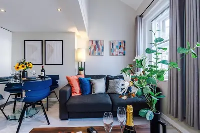 a living room with a couch and a table at NEW! Stunning City Centre 2-bed apartment in Liverpool by 53 Degrees Property, Ideal for Small Groups, Sleeps 6! in Liverpool